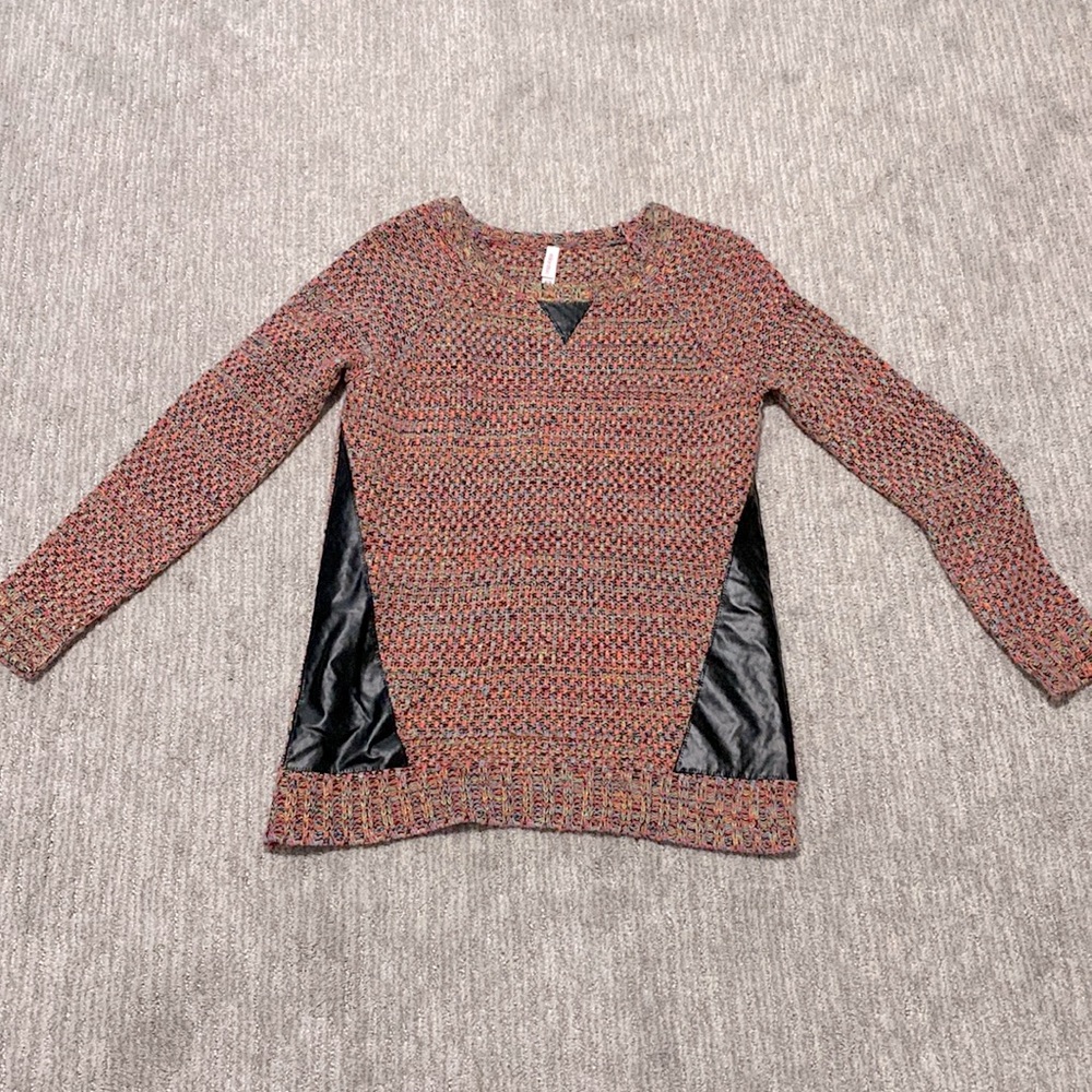 Pink sweater with black faux leather panels